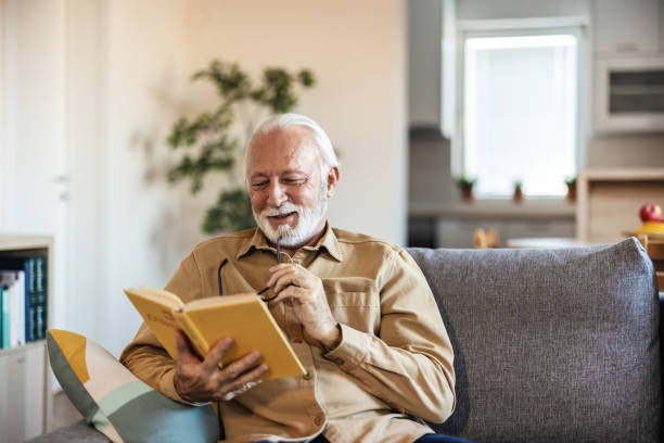 istock Cropped shot of a handsome senior man reading a book while working in his study. 1889509338