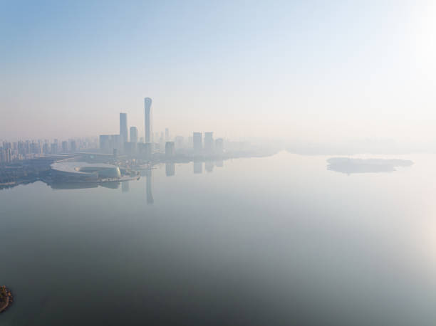 istock The calm lake surface and urban architecture 1889511422