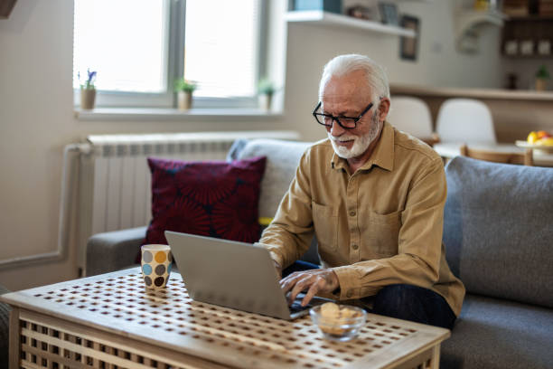 istock Shot of a senior businessman working from home while using his laptop. 1889511940
