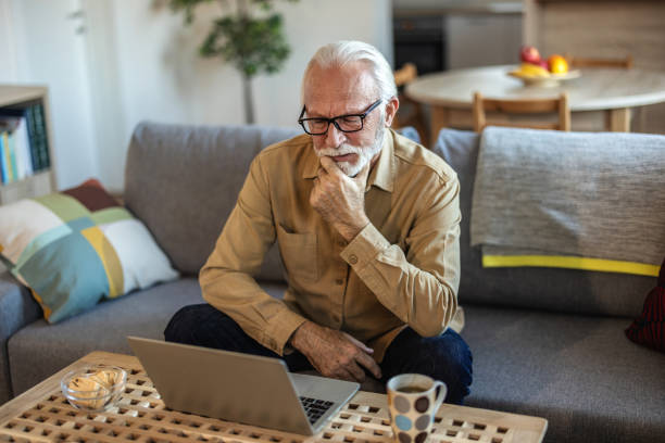 istock Shot of a senior businessman working from home while using his laptop. 1889512468
