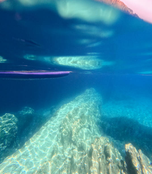 istock A rock bathed in sunbeams under the sea 1889513988