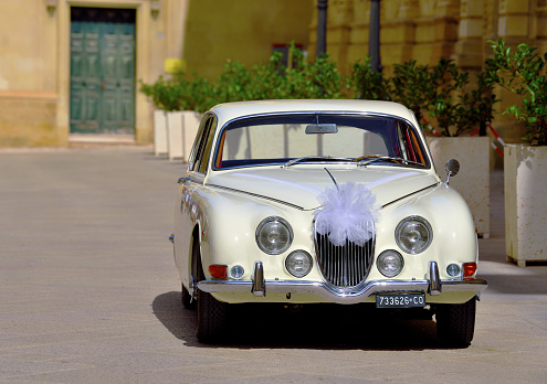 vintage jaguar 3.8 s wedding car parked by the basilica santa croce Sep 23 2023 Lecce Italy