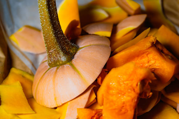 Freshly cut and peeled butternut, peelings for compost