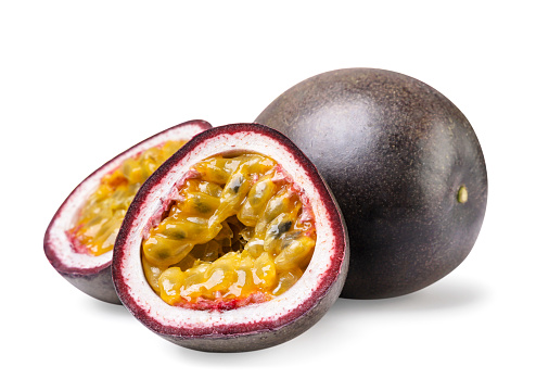 Ripe passion fruit and two halves close-up on a white background. Isolated