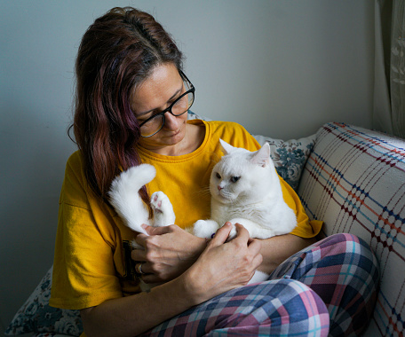 Woman petting her beautiful cat