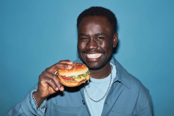 istock Cheerful Young Black Man Holding Burger 1889561430