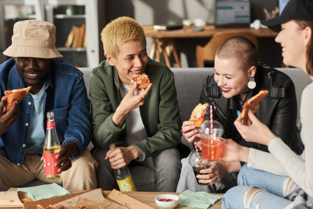 istock Happy Young Adults Enjoying Pizza 1889561966