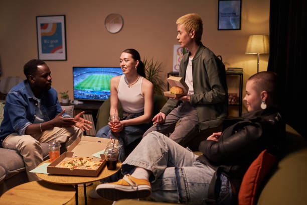 istock Four Young Friends Talking in Living Room 1889562532
