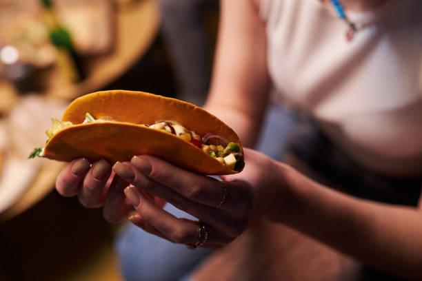 istock Woman Holding Appetizing Taco 1889562540