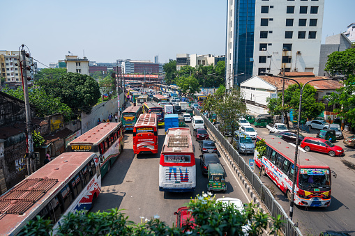 Busy main road in Gulshan district of Dhaka, capital city of Bangladesh. Vehicles and people visible.