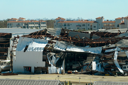Boat station destroyed by hurricane wind in Florida coastal area. Consequences of natural disaster.