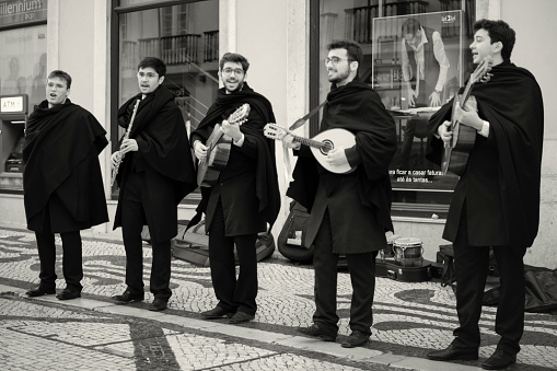 Lisbon, Portugal - January 15, 2023: A group of college students perform at the Rua Augusta street in Lisbon downtown.