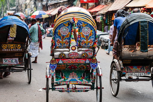 Rickshaws on the streets of Sadarghat on the banks of the Buriganga River in Dhaka, Bangladesh