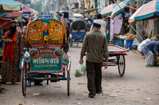Rickshaws on the streets of Sadarghat on the banks of the Buriganga River in Dhaka, Bangladesh