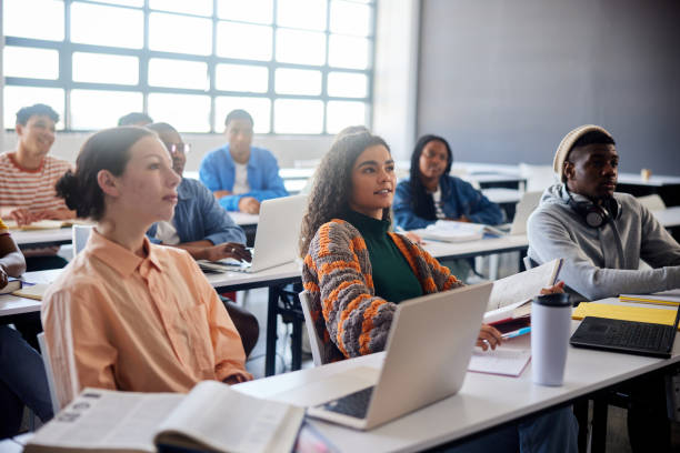 istock Diverse college students sitting at desks during a lecture at school 1889683990