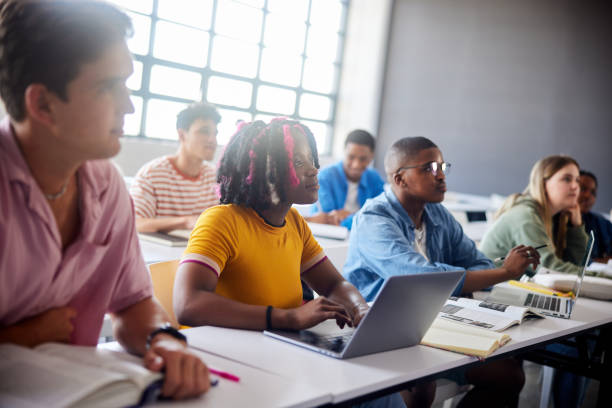 istock Smiling college student sitting with classmates during a school lecture 1889684556