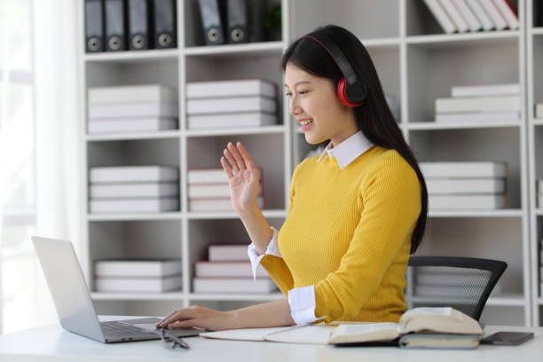 istock Asian female university student studying online seminar on laptop in university library. 1889686162