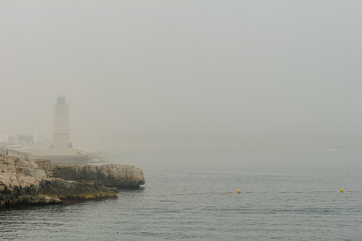 boats in the sea on foggy day