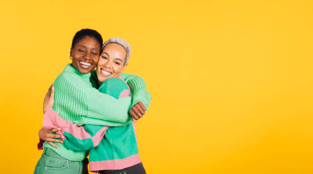 istock Young cheerful female couple in studio. 1889716612
