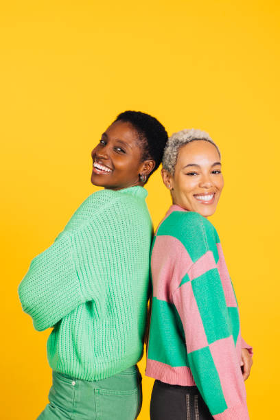 istock Young cheerful female couple in studio. 1889716622