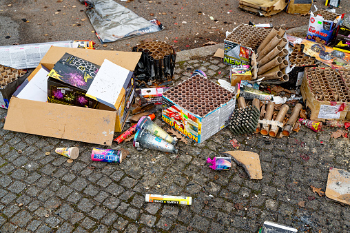 Berlin, Germany - January 1, 2023: Remains of a New Year's Eve celebration along a street.