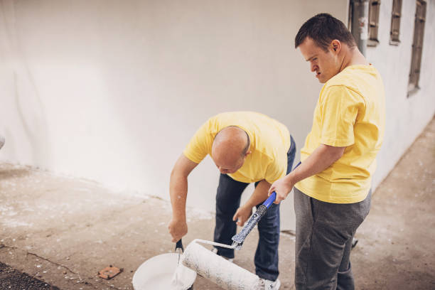 istock Volunteers painting wall together 1889817379