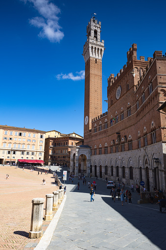 Siena, Italy - 10 August, 2023: Bell tower of the Palazzo Pubblico in Siena, Italy