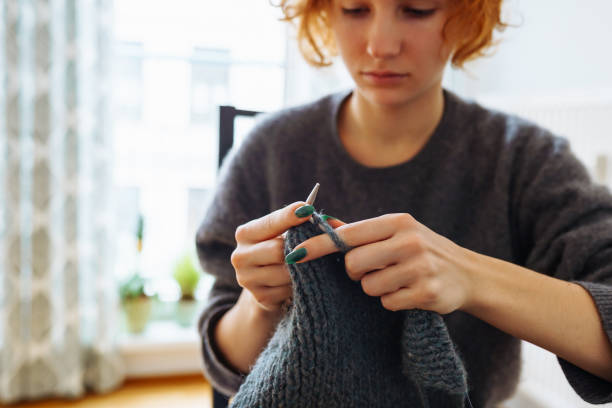 istock young woman knits wool product 1889872017