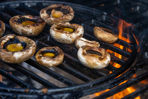 Close-up of mushroom cooking on barbecue grill.