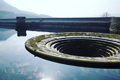 The Ladybower Reservoir shaft spillway, also known as the plug hole, in the Dark Peak of the Peak District, Derbyshire, UK