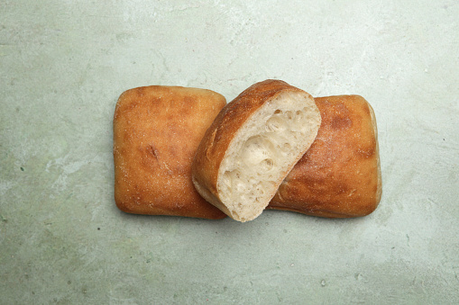 One unsliced Tiger Bread Loaf lying on a white base and on a white back ground. A good image for a Baker or delicatessen.