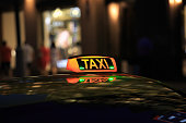 taxi lantern on the roof of the car at night