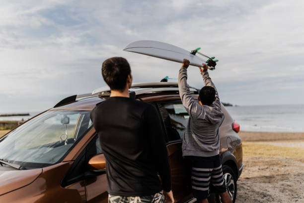 istock Friends taking surfboard in the car at beach 1889939208