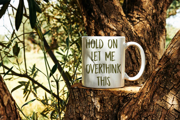 istock hold on let me overthink this on cup on olives tree trunk podium 1889948566