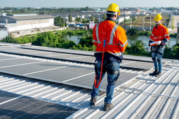 istock Back of technician worker stand and discuss about installation and maintenance the solar cell panels on rooftop of factory building. Green sustainable energy for good environment concept. 1889970888