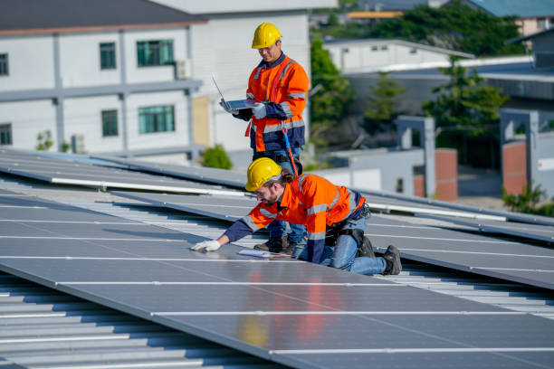 istock One of technician worker touch to check and maintenance solar cell panels and other co-worker hold laptop to work together on rooftop of factory building. 1889972678