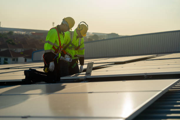istock Caucasian technician workers look at laptop to check and maintenance solar cell panels on rooftop of factory or the building. Green and sustainable energy concept. 1889973746