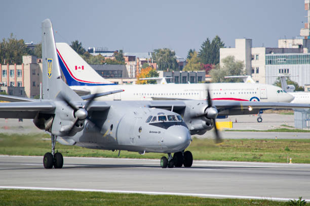Ukrainian Armed Forces Antonov An-26 landing Ukrainian Armed Forces Antonov An-26 slowing down after landing in Lviv with Royal Canadian Air Force Airbus CC-150 Polaris in the background antonov an 26 stock pictures, royalty-free photos & images
