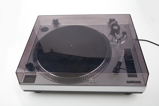 Turntable with cover isolated on bright background.