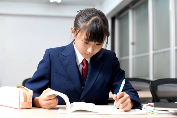 istock Asian female student in uniform studying in the classroom 1890064199