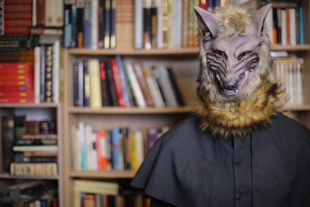 istock Human wearing spooky wolf mask with library in the background 1890075661