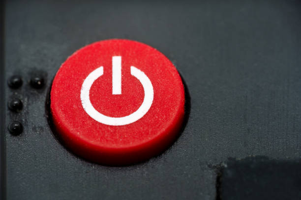 Red power button of a TV remote, close up macro.