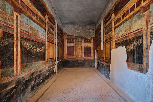 Naples, Italy - October 31 2023: Fresco wall mural and decorative elements on a wall at Villa dei Misteri, Villa of the Mysteries in the archaeological site of Pompeii