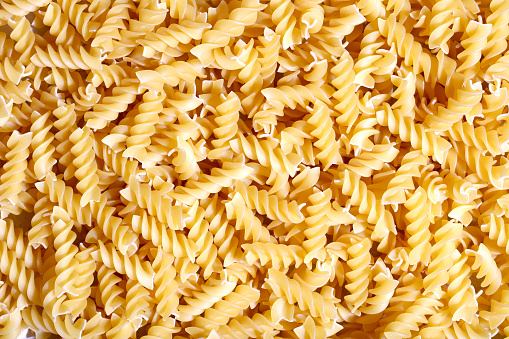 Italian fusilli pasta close-up (uncooked). Can be used as a background.