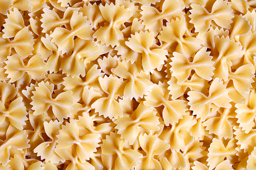 Bow Tie pasta close-up (uncooked). Can be used as a background.