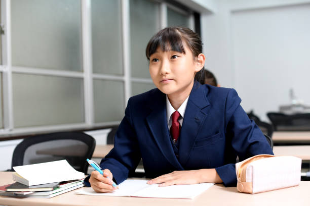 istock Asian female student in uniform studying in the classroom 1890105158