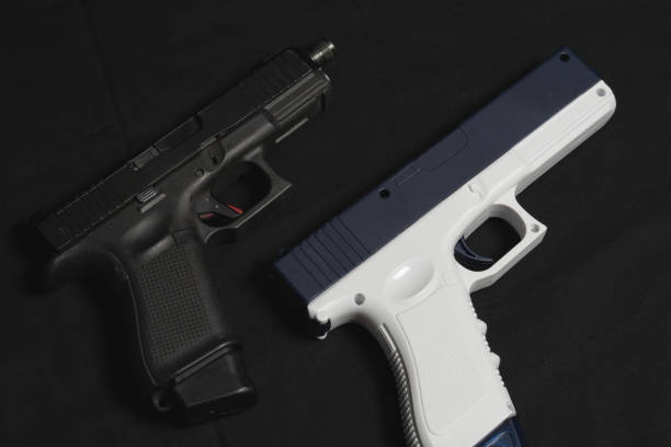 istock Real g19 9mm pistol and toy water gun. 1890107779