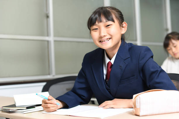 istock Asian female student in uniform studying in the classroom 1890107785