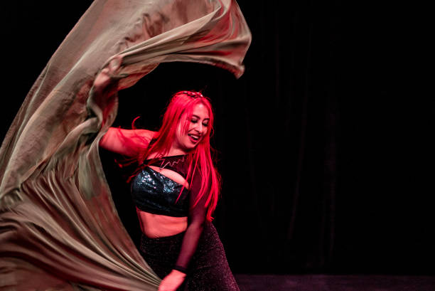 Mid adult dancer performing dance in the theater stage