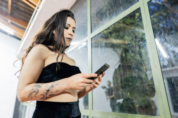 istock Mid adult woman using mobile phone indoors 1890157420
